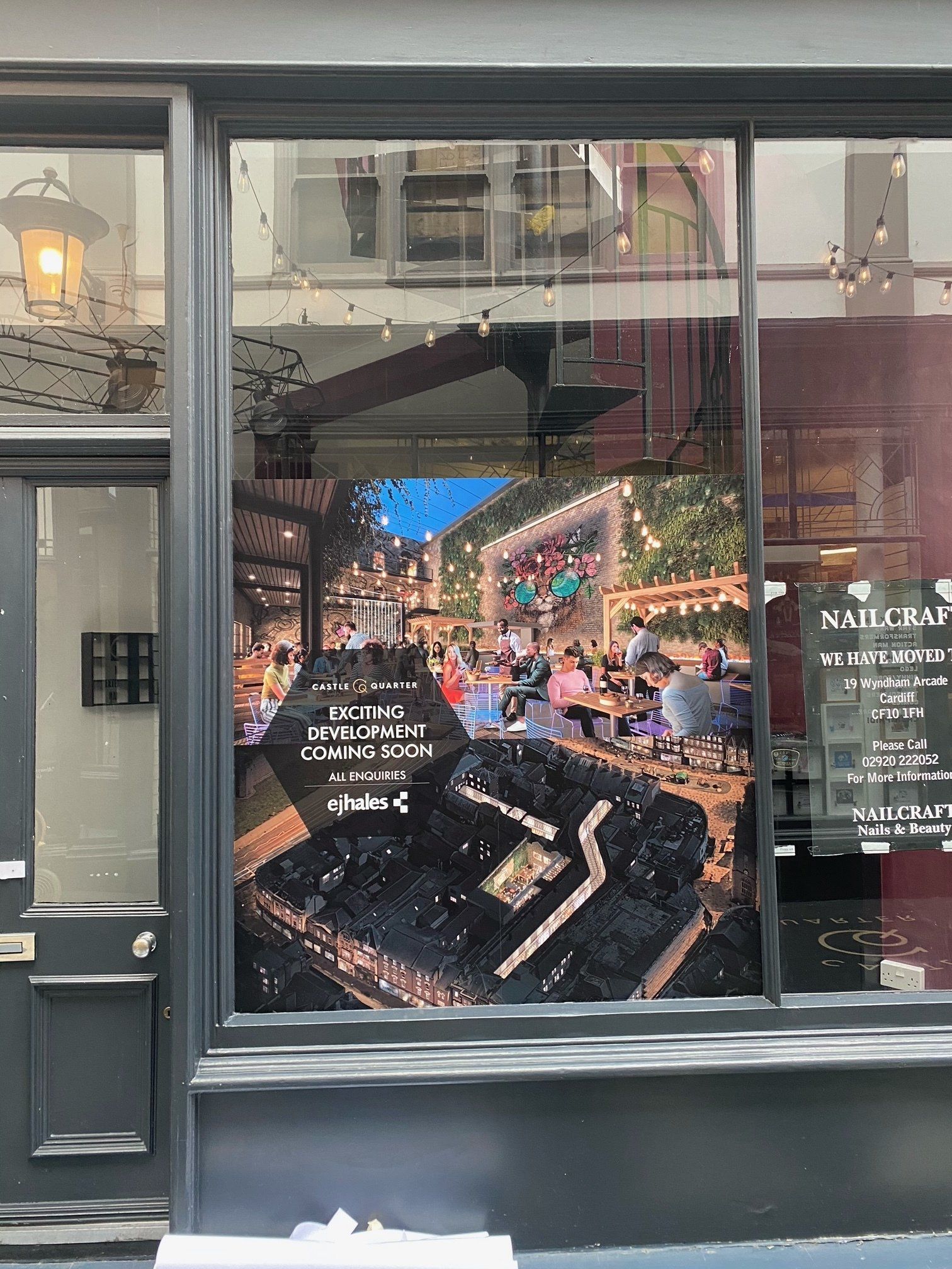 A store front with a picture of a city in the window.