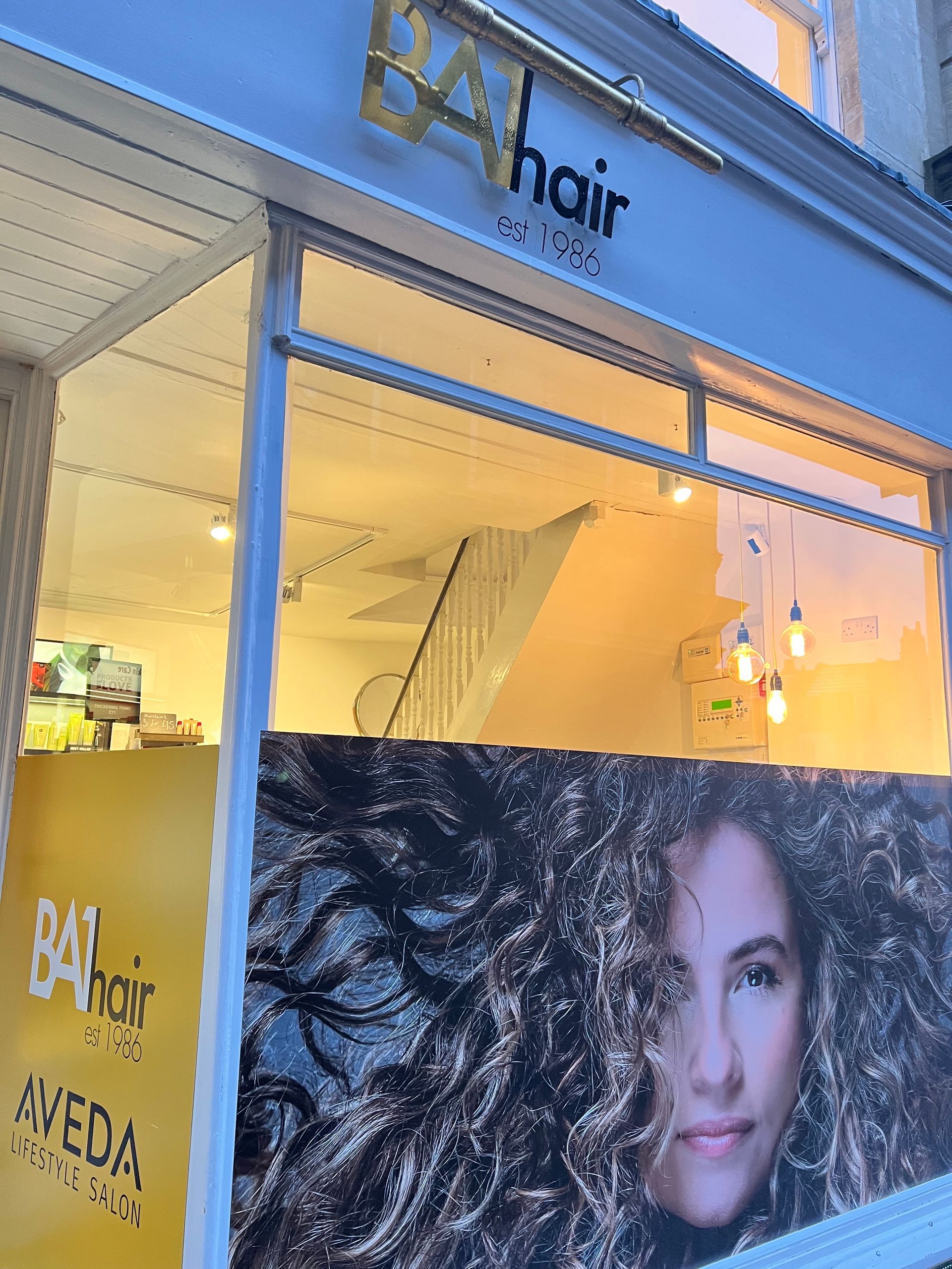 A hair salon with a picture of a woman in the window