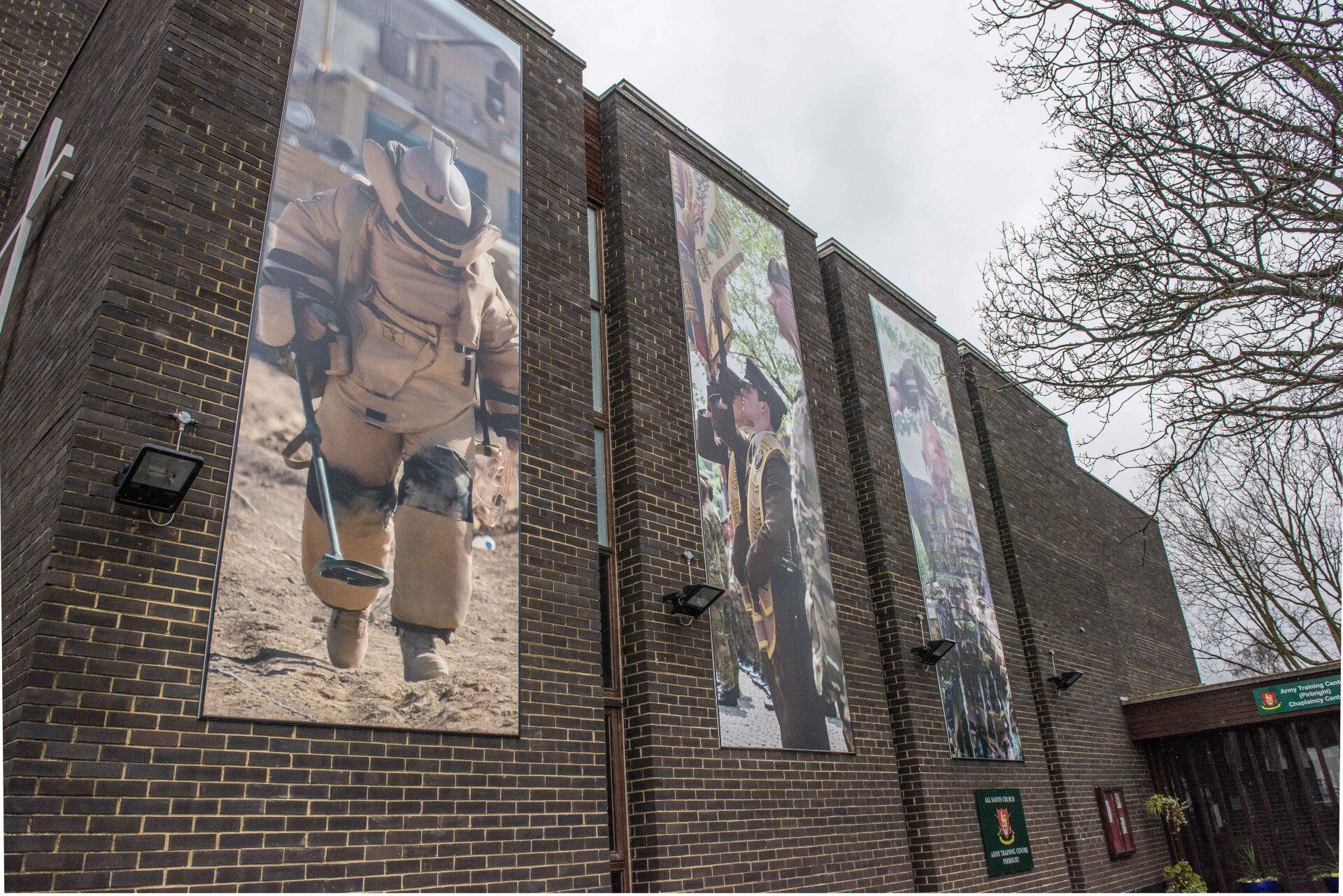 A brick building with a picture of a soldier on the side