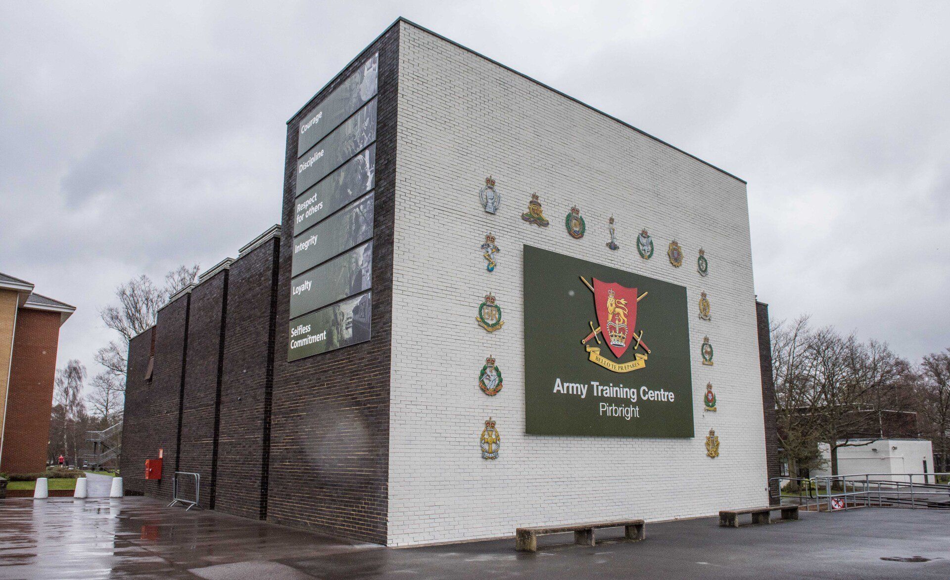 A large building with a sign on the side that says army training center