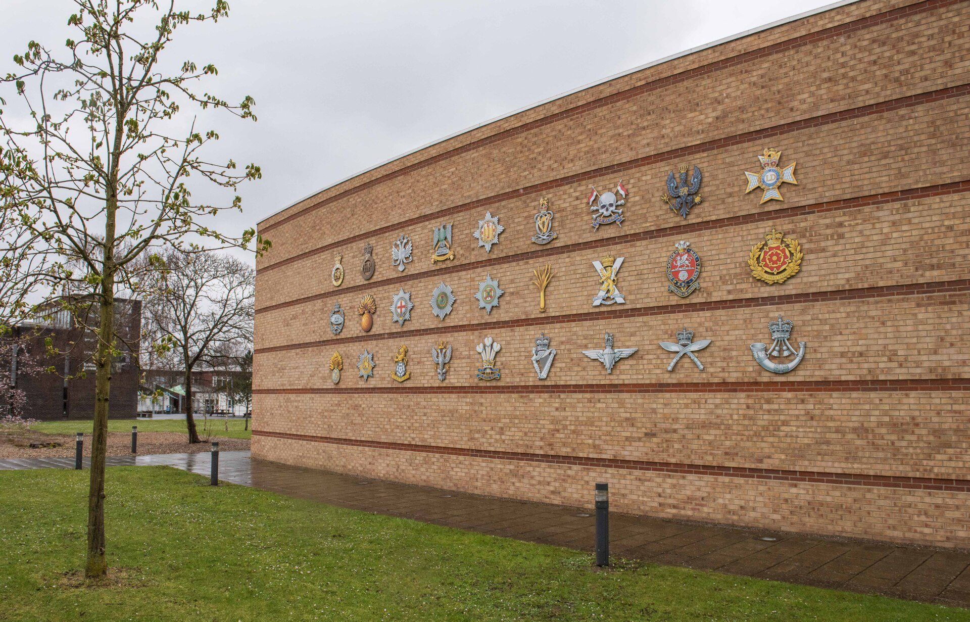 A large brick wall with a lot of emblems on it