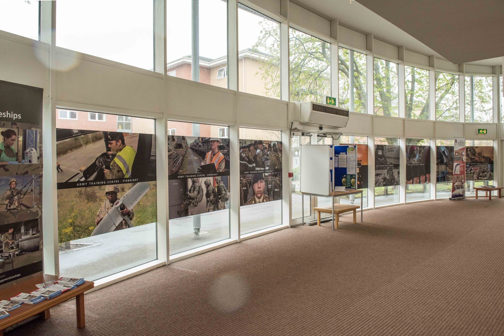 A large room with a lot of windows and pictures on the wall.