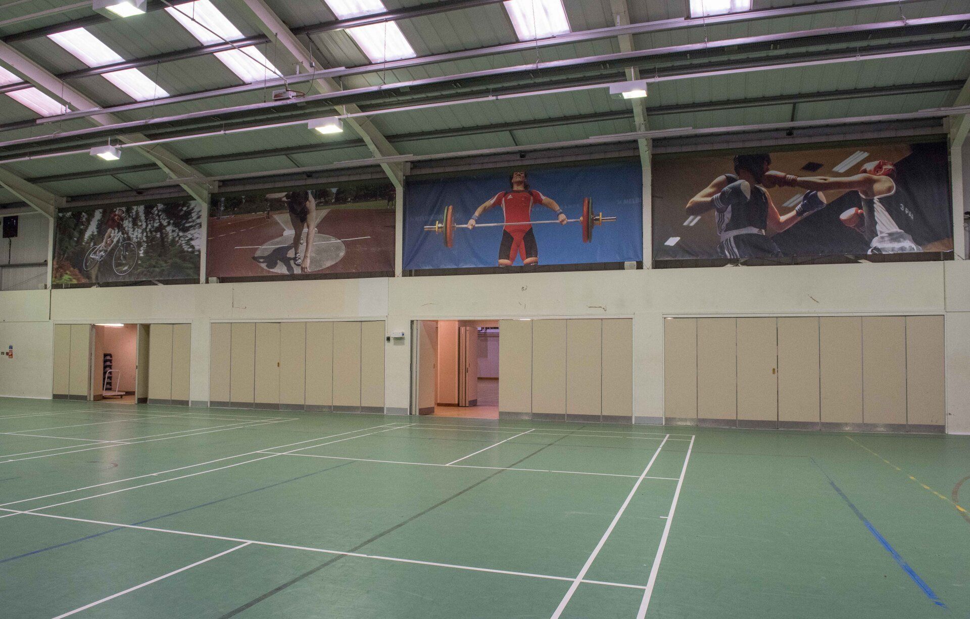 A large empty gym with a mural on the wall