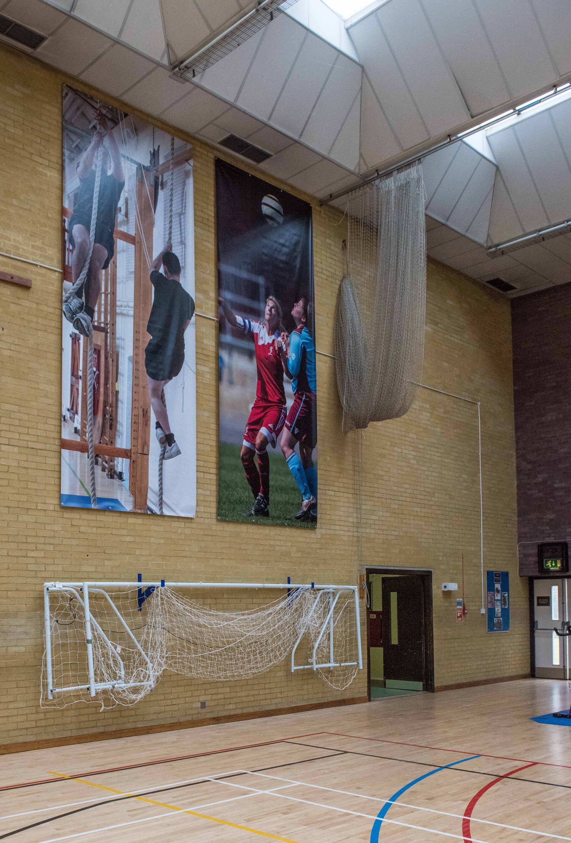 There are a lot of pictures on the wall of a gym.