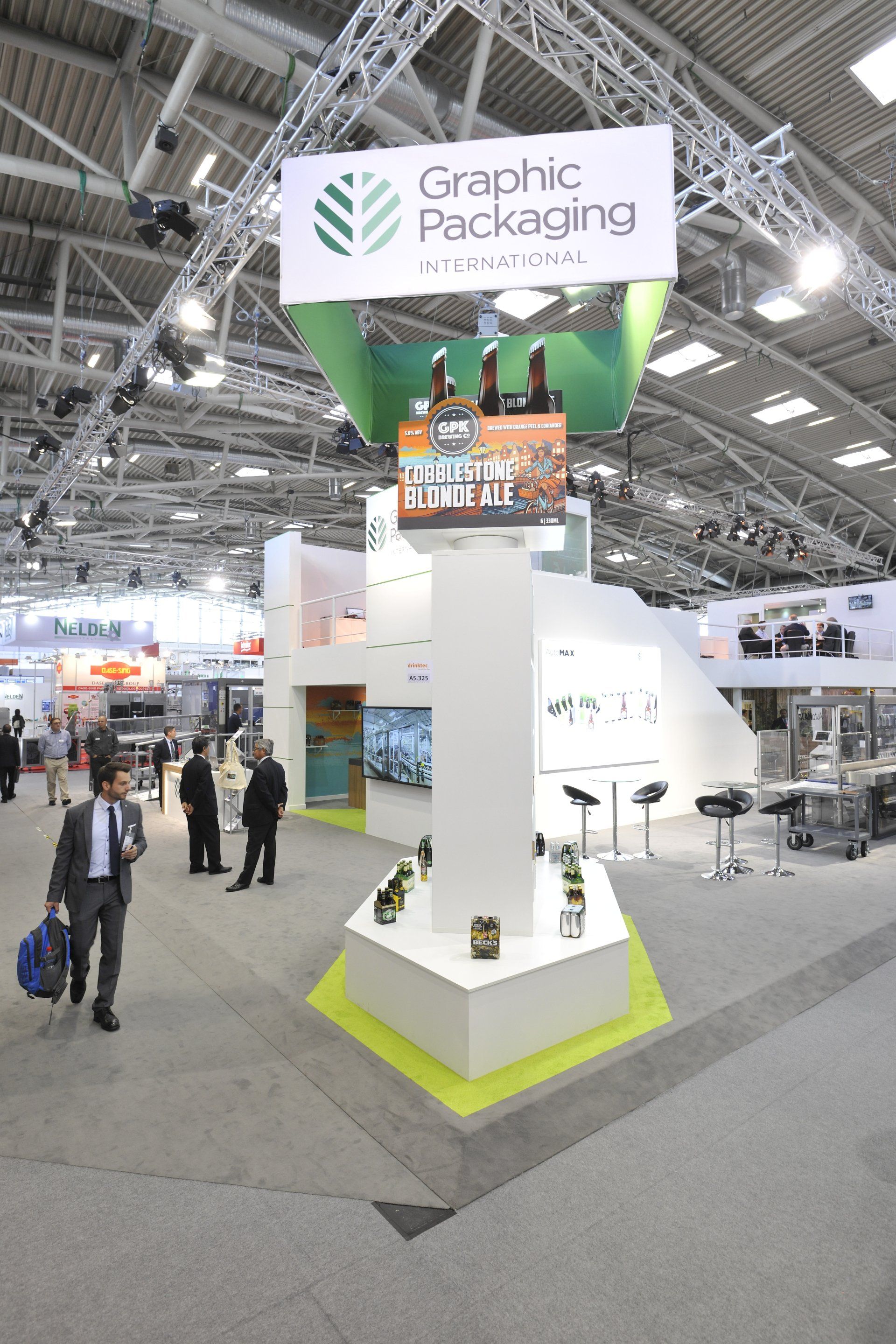 A sign for graphic packaging hangs from the ceiling of a building