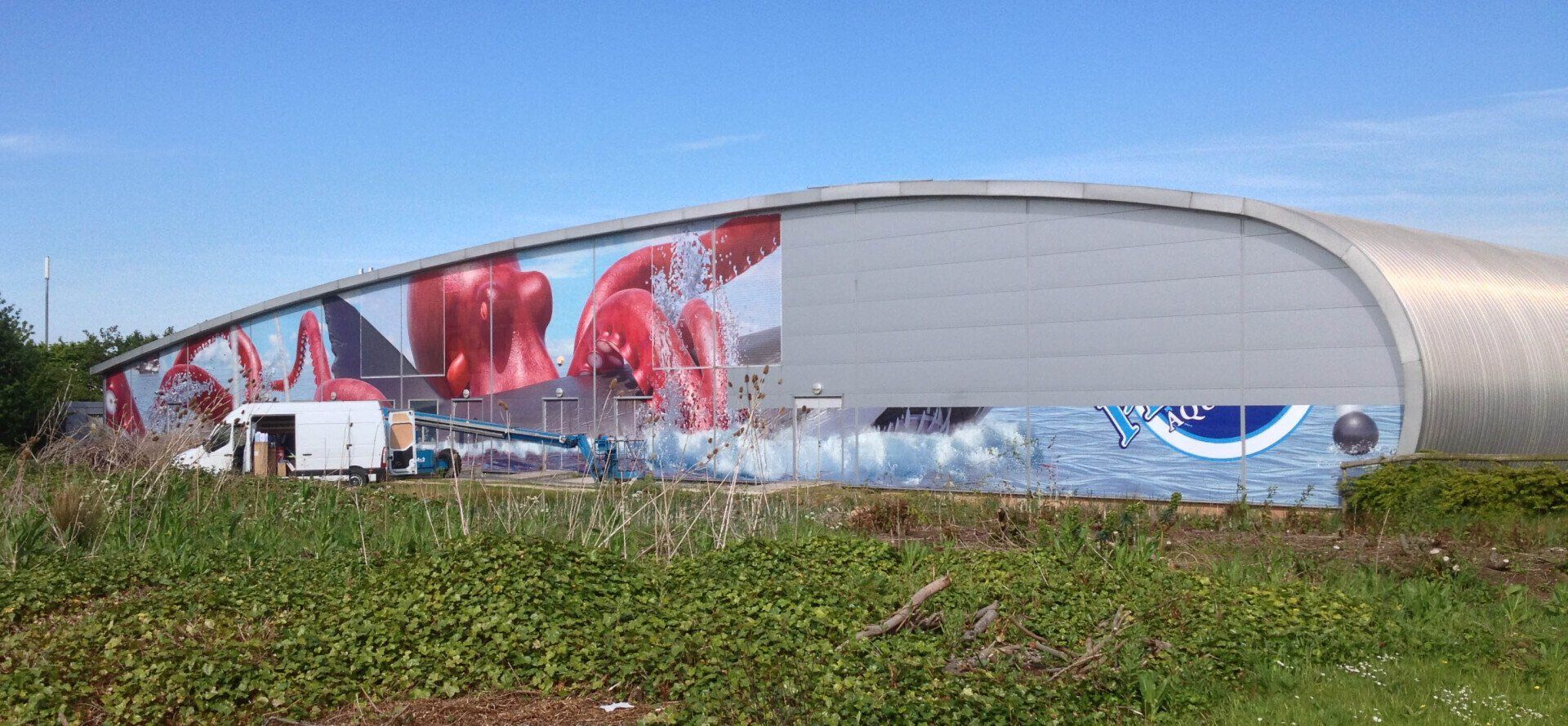 A large building with graffiti on the side of it.