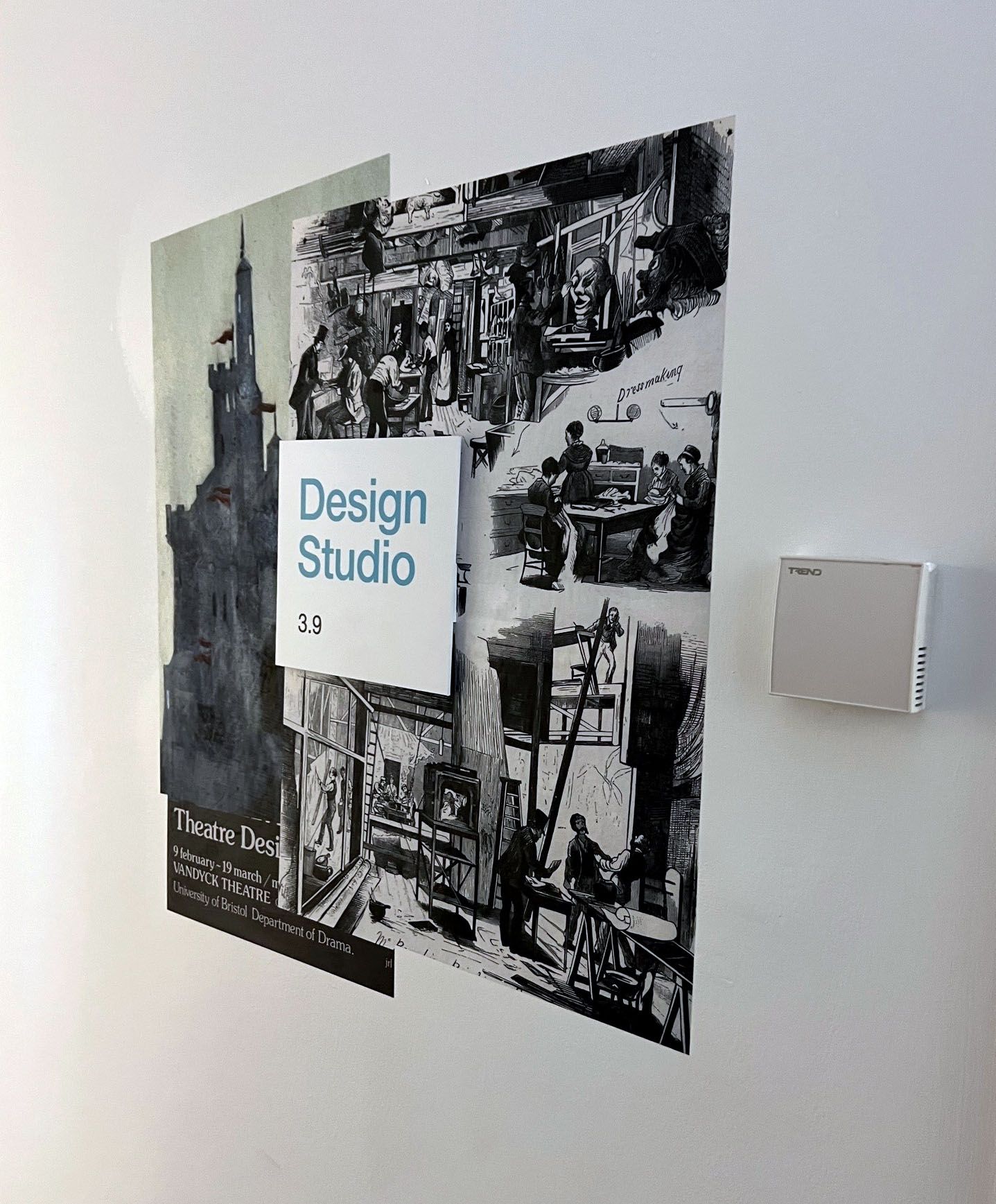 A poster on a wall that says design studio on it