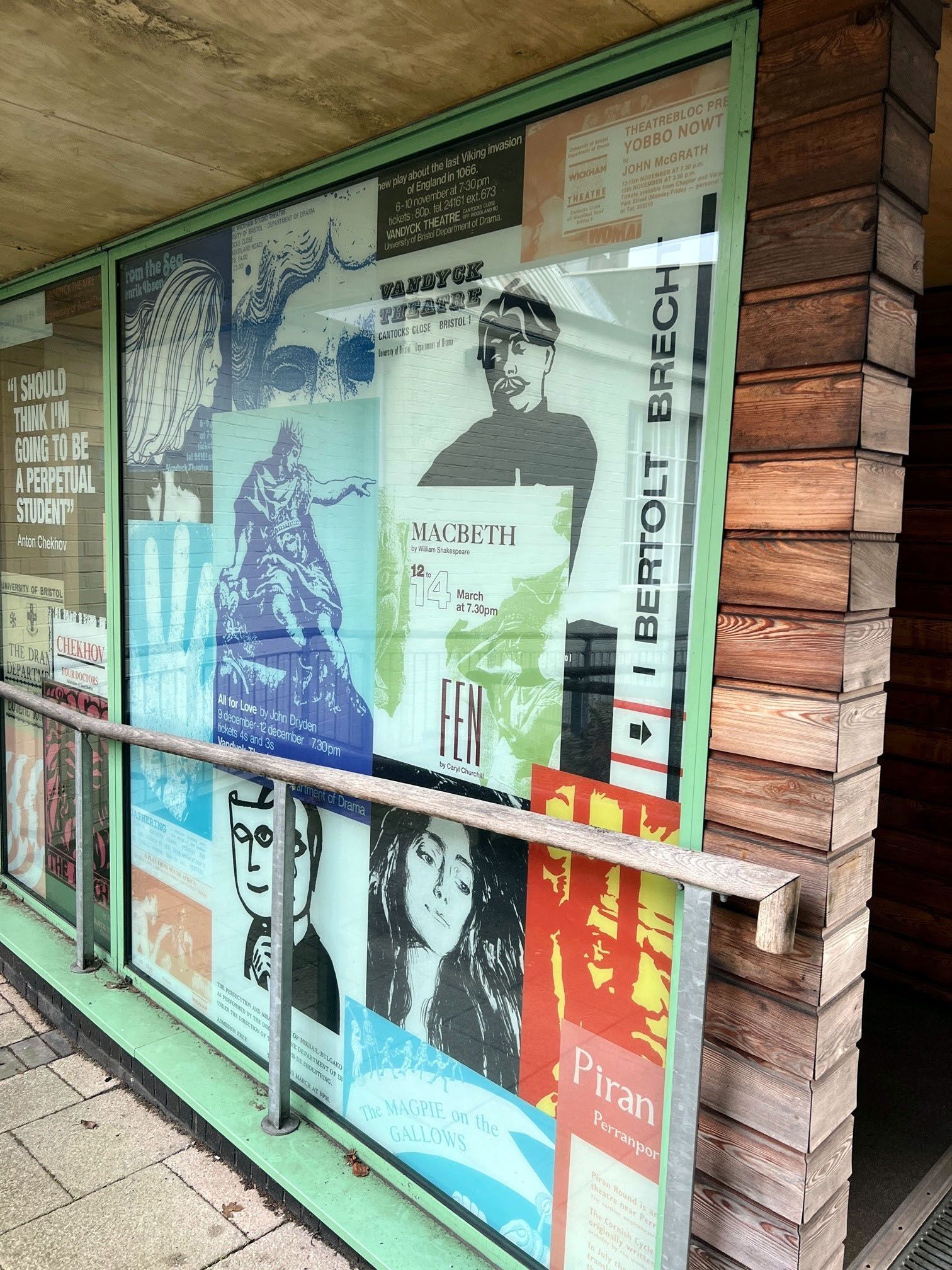 A window with a lot of posters on it