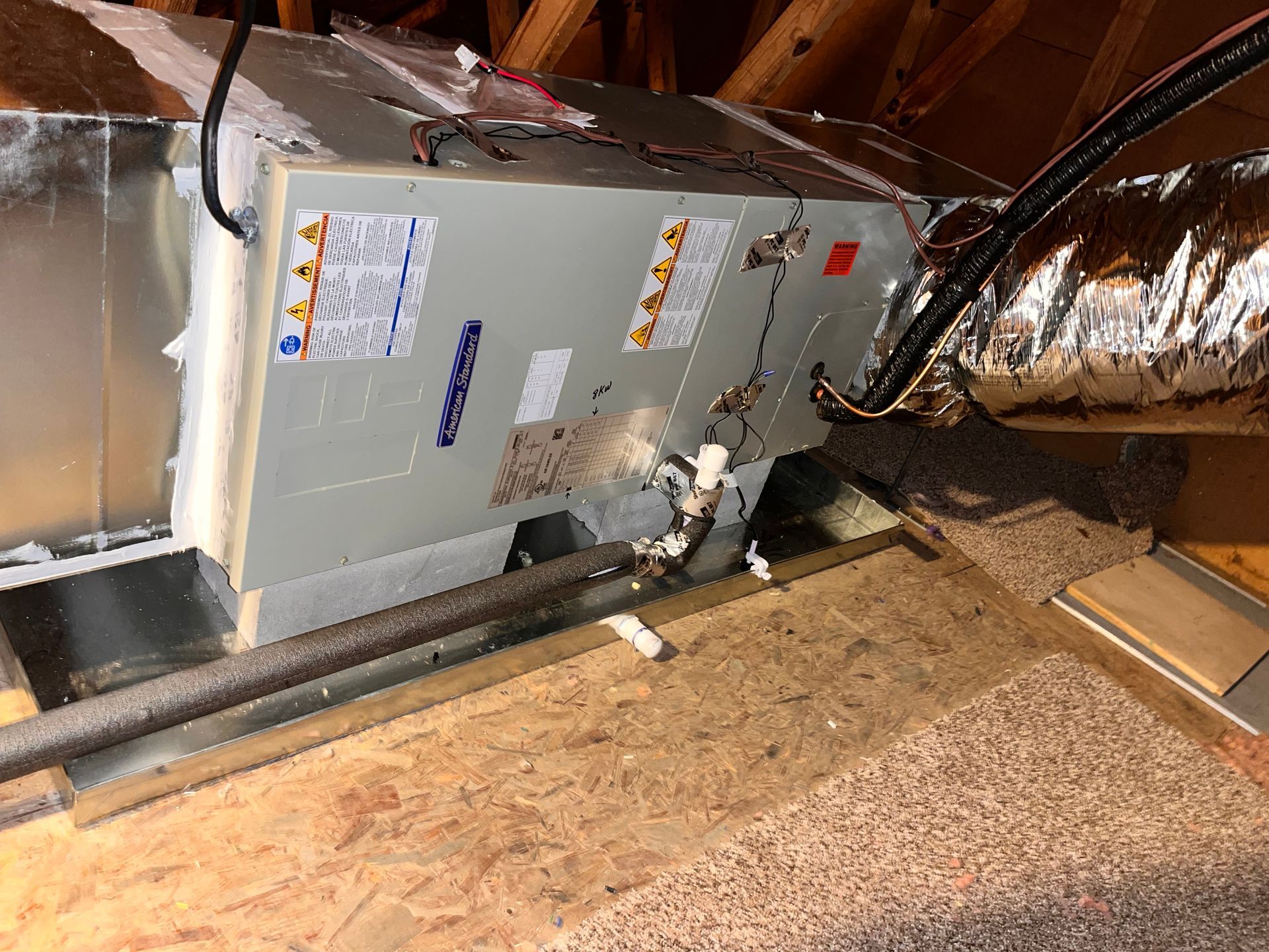 an air conditioner is sitting in the attic of a house .