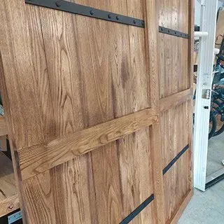 A close up of a wooden sliding barn door in a store.