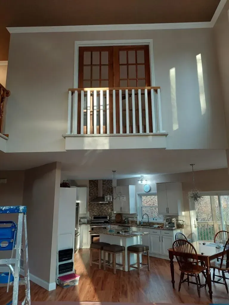 A kitchen with a balcony and a table and chairs