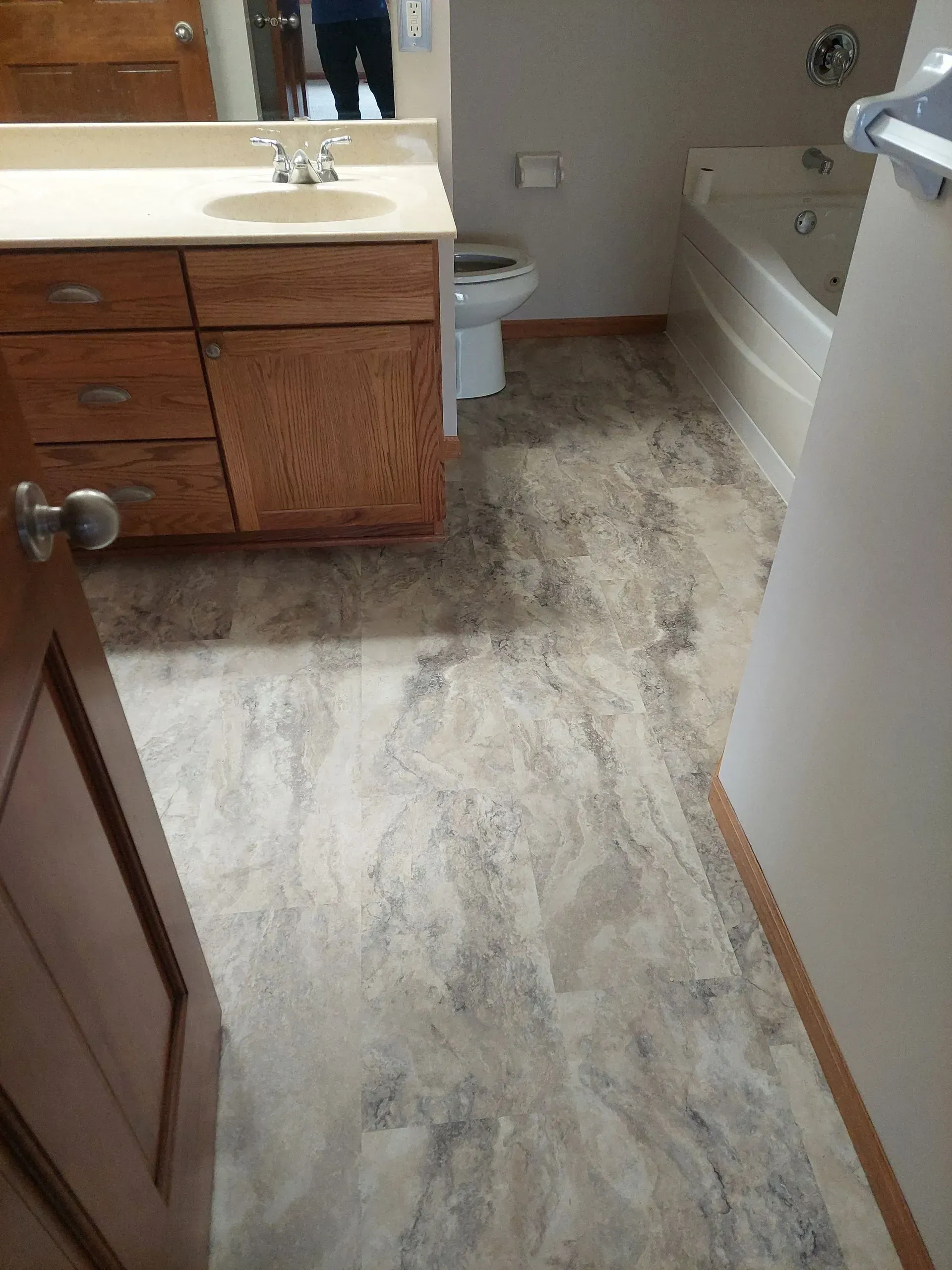 A bathroom with a sink , toilet , tub and mirror