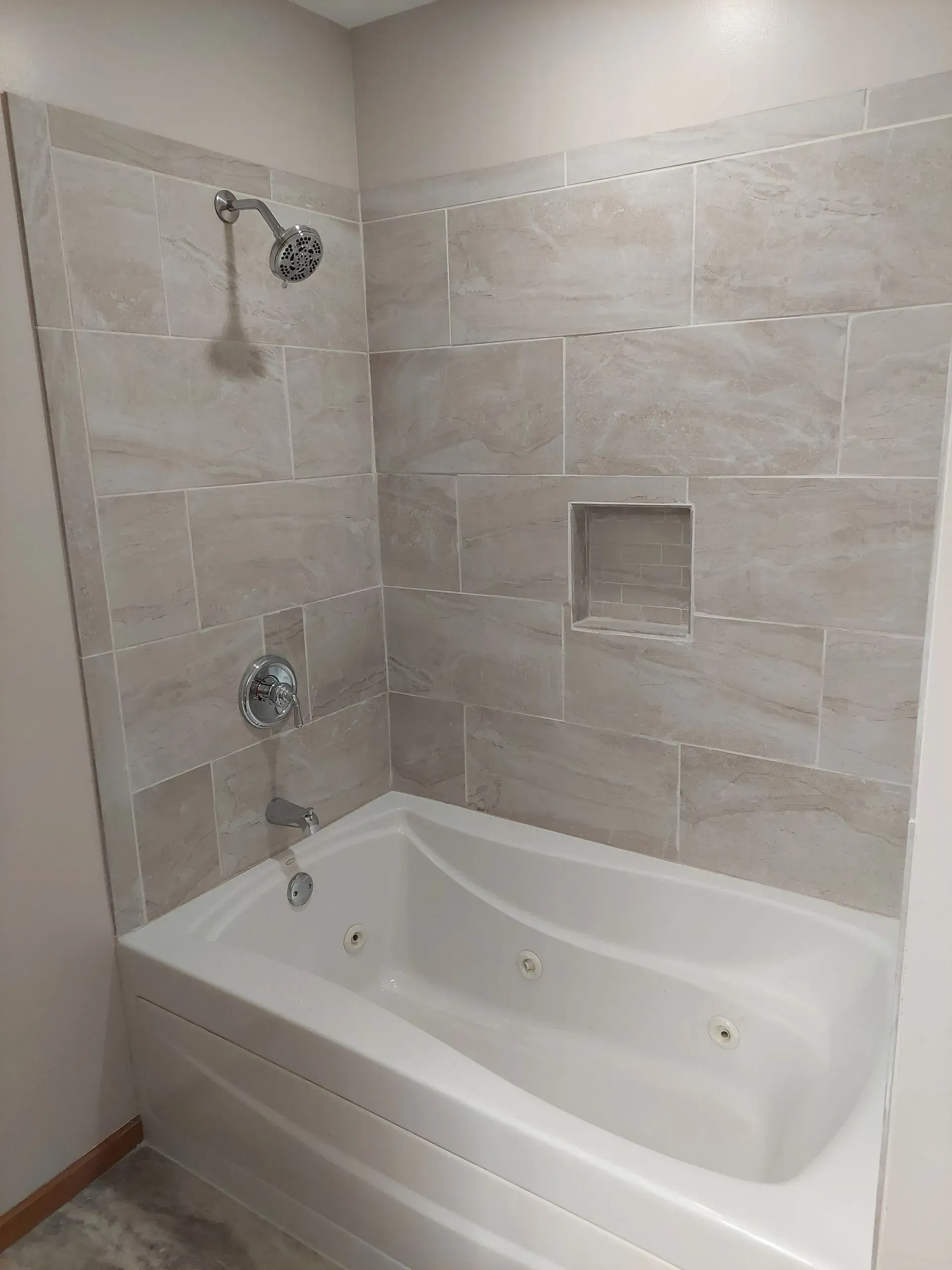 A bathroom with a bathtub and a shower.