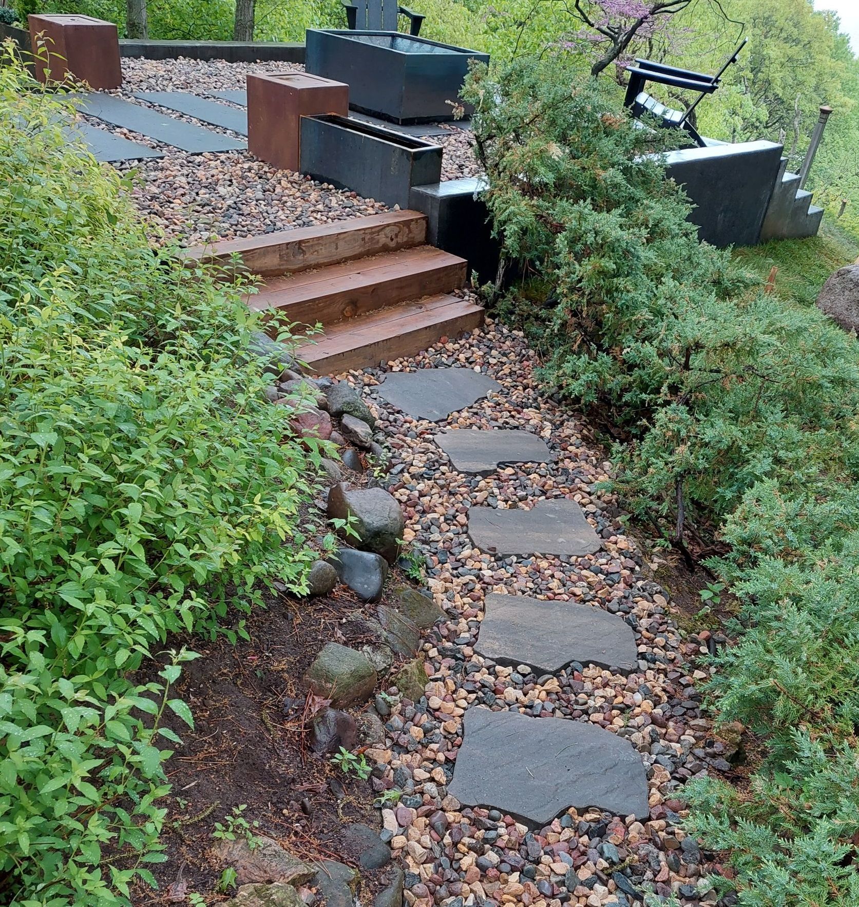 A stone walkway with steps leading up to a bench