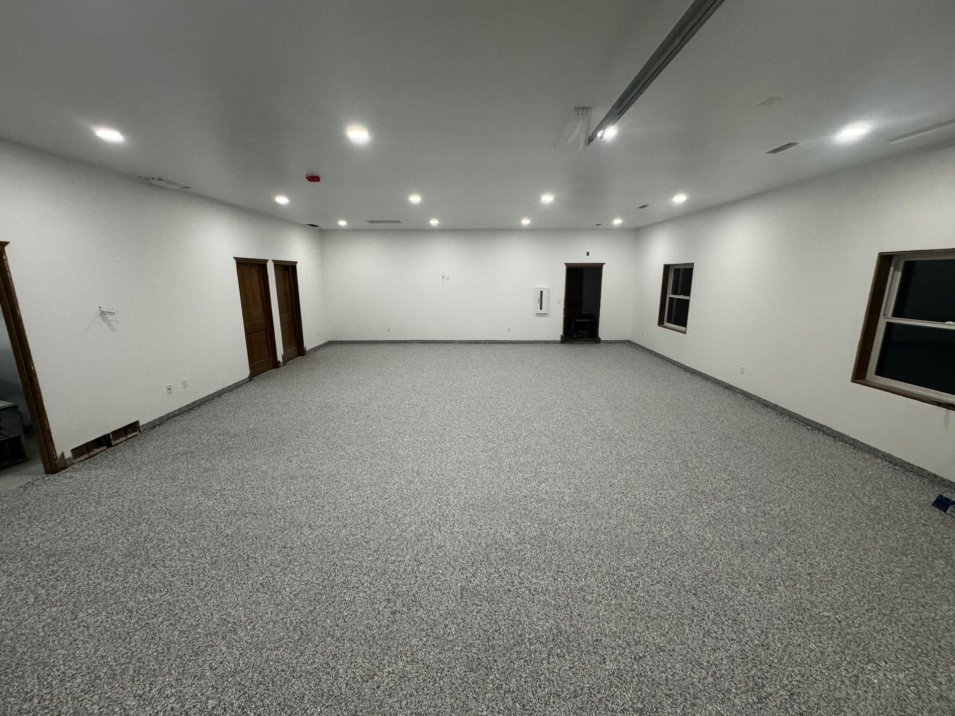 A large room with a gray floor and white walls.