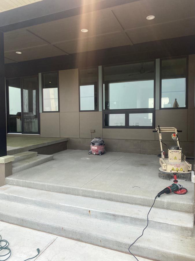 a vacuum cleaner sits on a concrete patio in front of a building