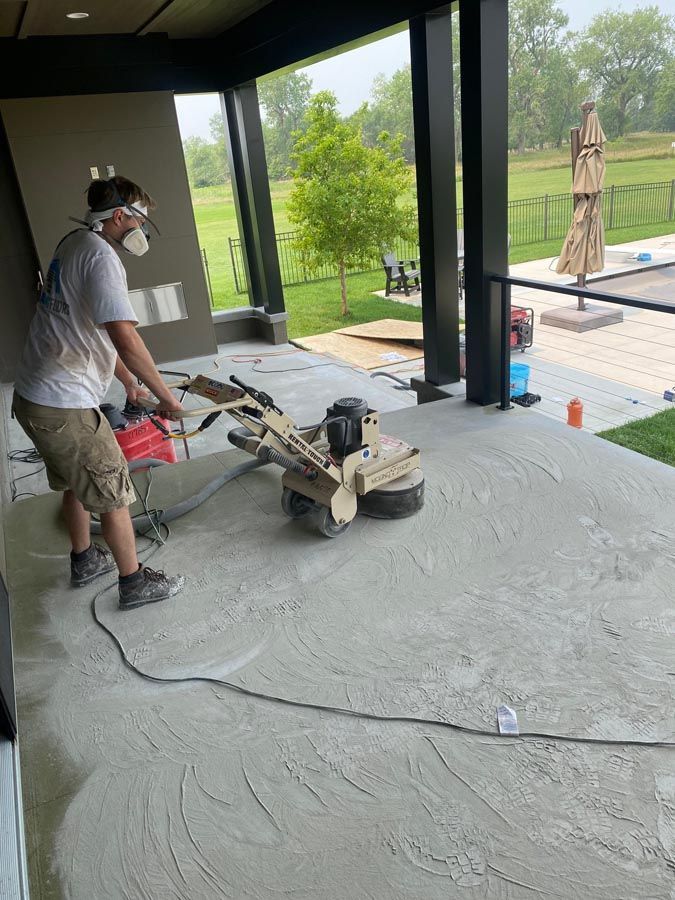 A man is using a machine to polish a concrete floor.