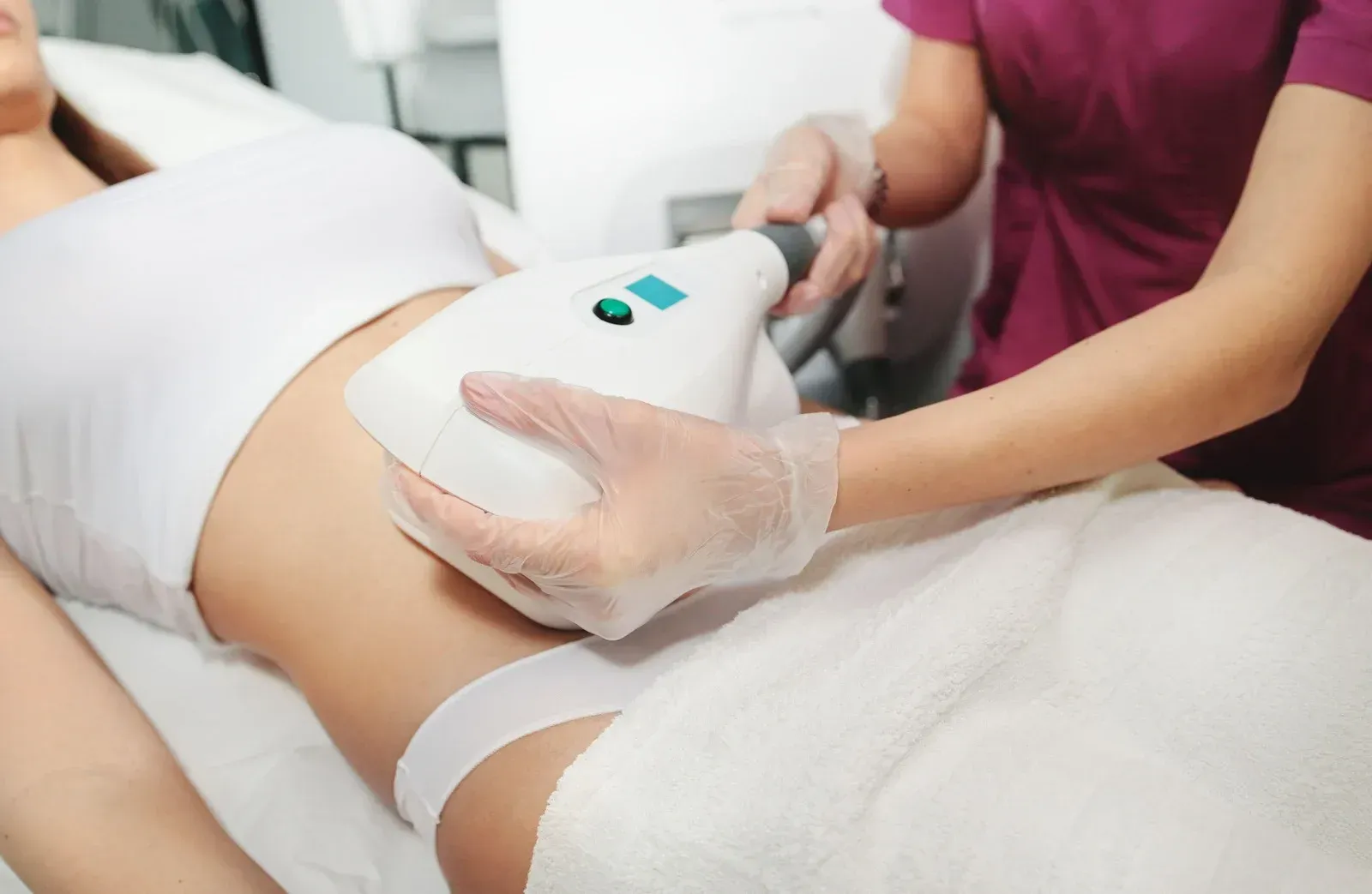 Woman in chair having arm checked by medical professional, medical setting.