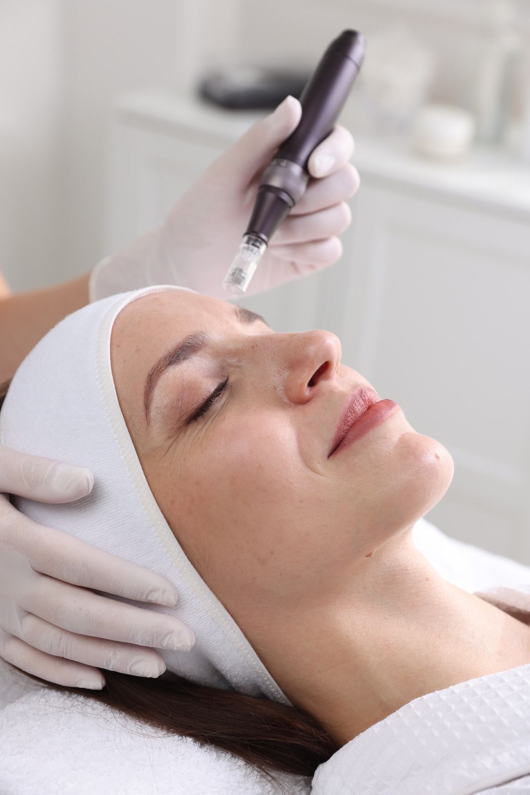 Doctor in white coat with stethoscope, taking notes on a clipboard while consulting with a patient.