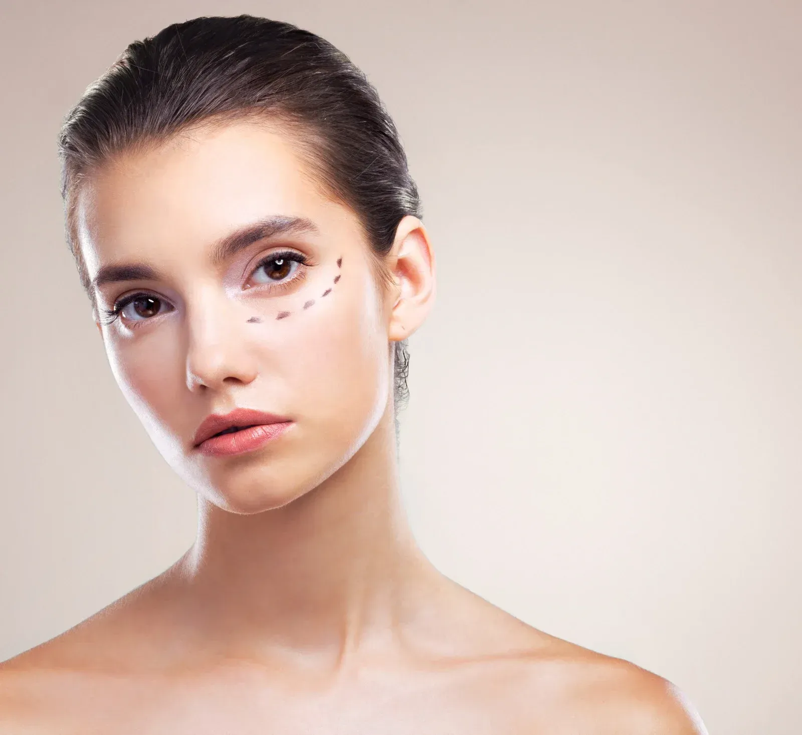 Doctor in white coat with stethoscope, taking notes on a clipboard while consulting with a patient.