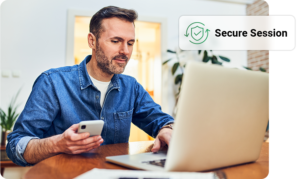 Man using laptop and phone, in a home setting,