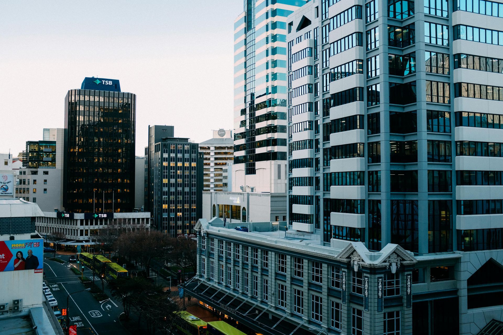 City buildings with a street below; modern architecture with dark and light facades.