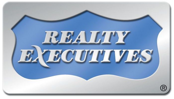 A blue sign that says realty executives on it