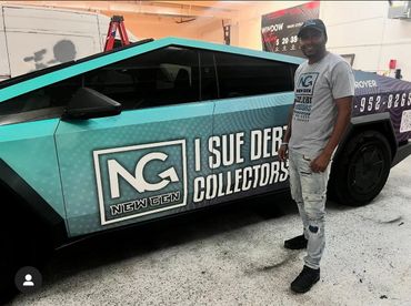 A man is standing in front of a car that says i sue deb collectors