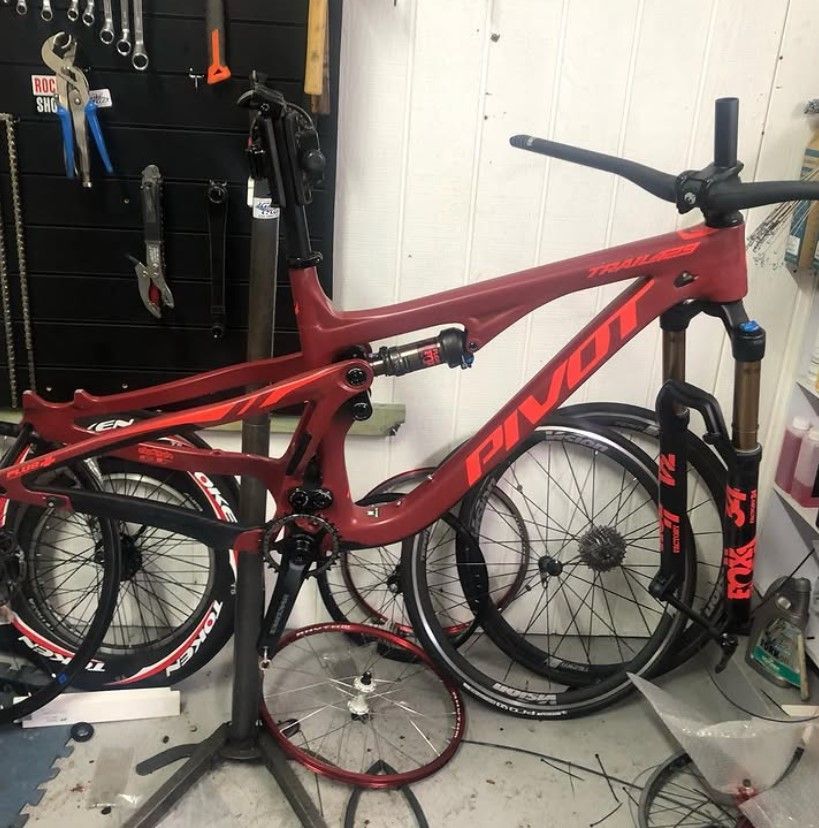 A Red Pivot Bike Is Sitting On A Stand In A Garage — Active Cycles In Raymond Terrace, NSW