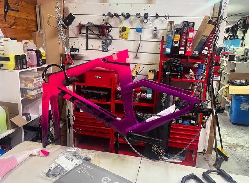 A Purple And Pink Bicycle Frame Is Sitting On A Table In A Workshop — Active Cycles In Raymond Terrace, NSW
