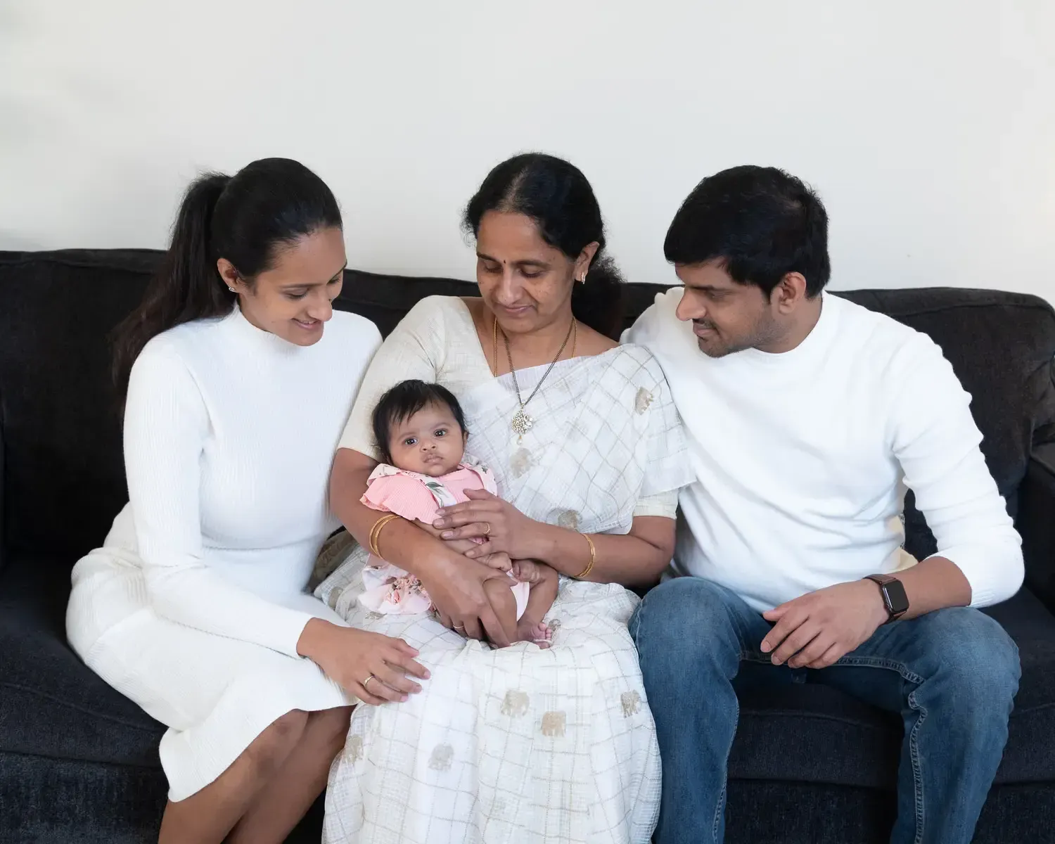 A family at home with their newborn.