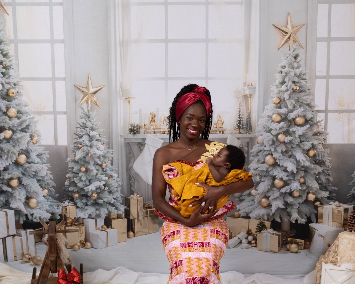 Mom with baby in front of fireplace