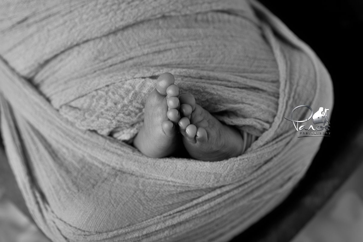 Newborn girl feet close up shot.

