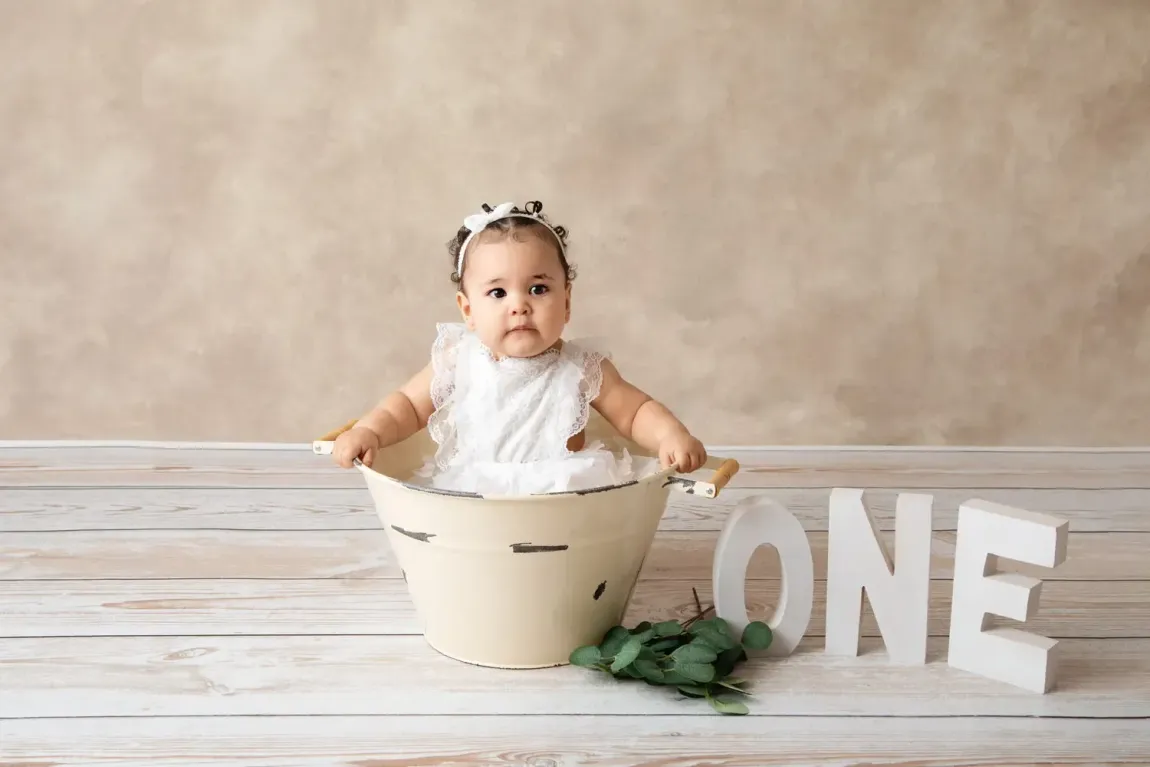 First Birthday for girl. Minimalist scene. Beige and white