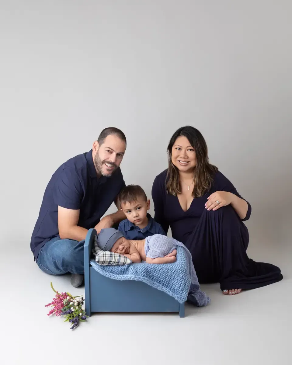 A family with toddler boy and newborn brother