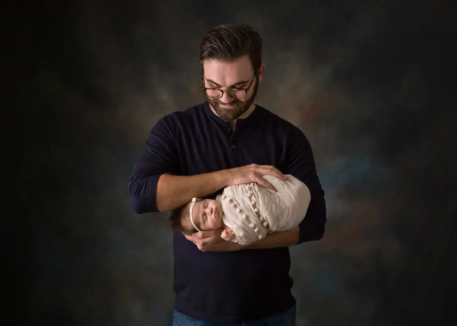 Dad holding newborn girl.