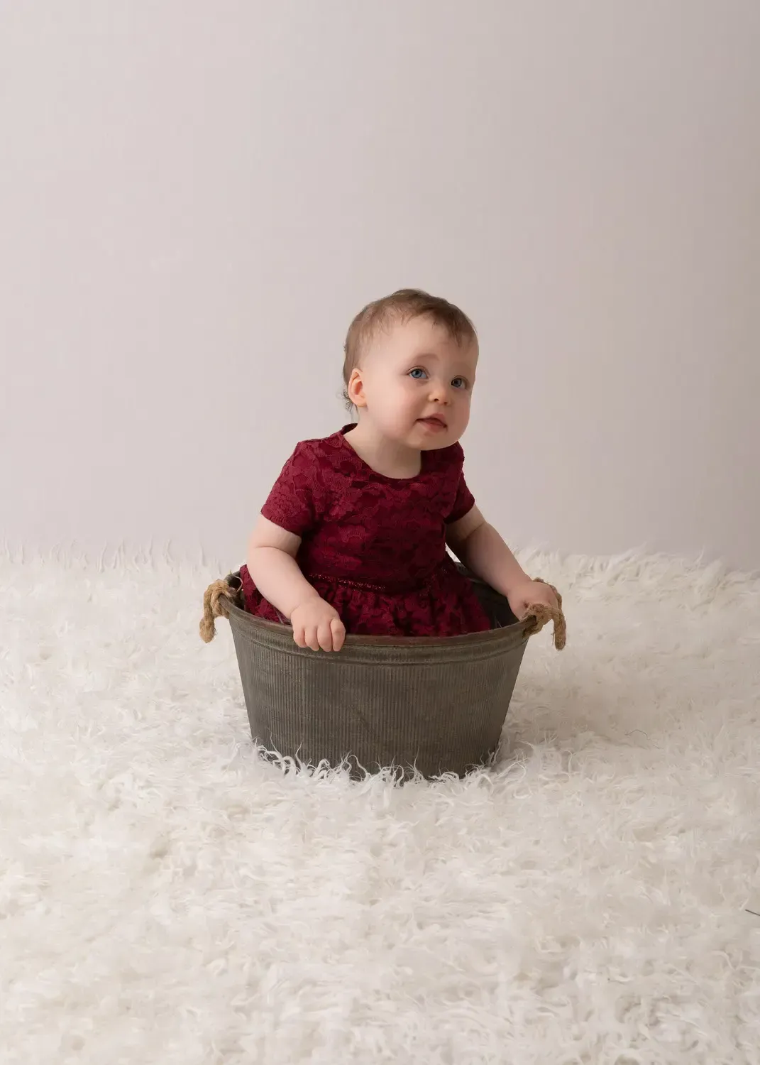 Glendale baby pictures. Baby girl in wine colored dress in bucket. First B day