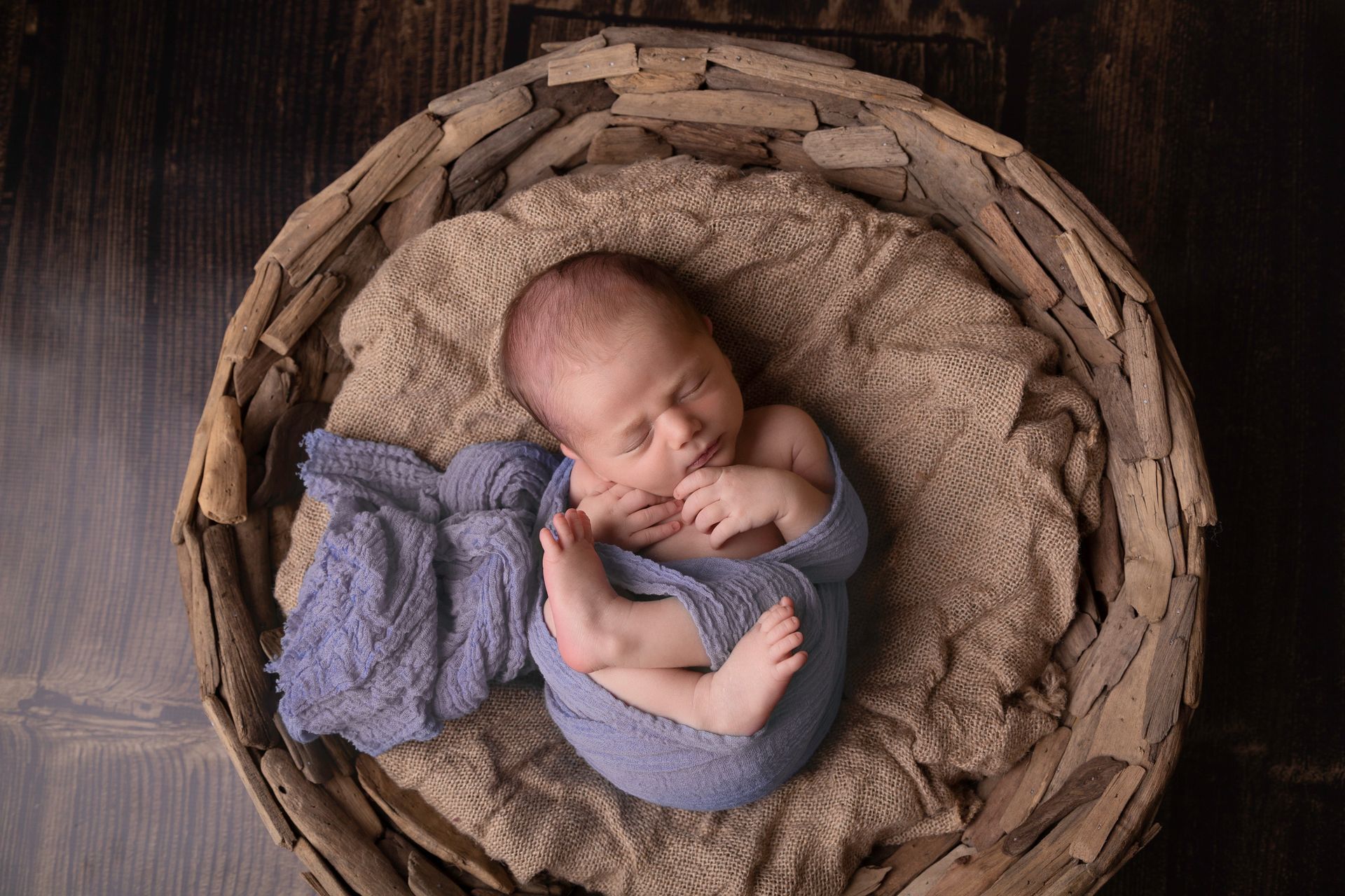  Newborn boy wrapped in blue in bowl prop