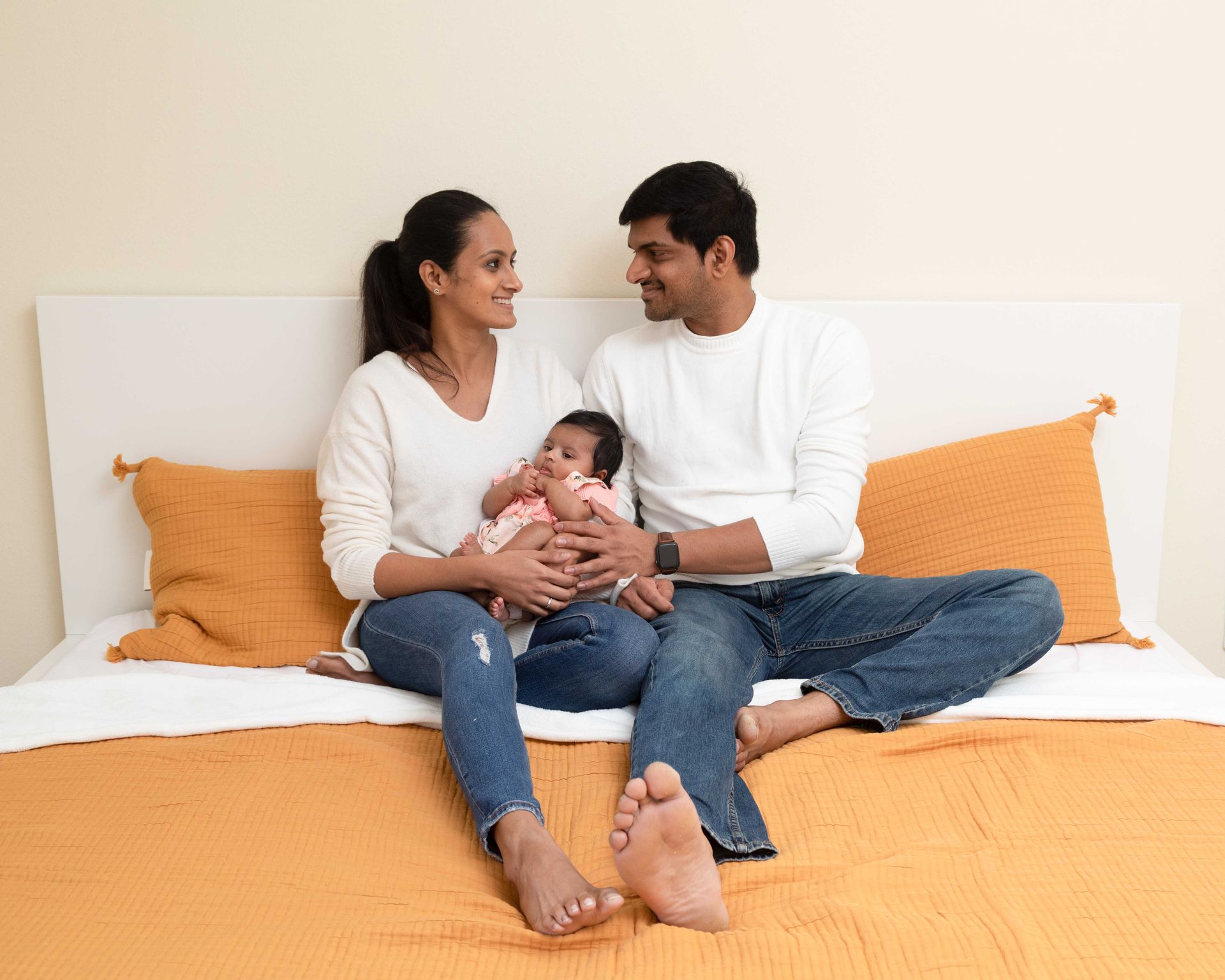 Young couple with newborn girl at their home in Los Angeles. Lifestyle newborn photo shoot.