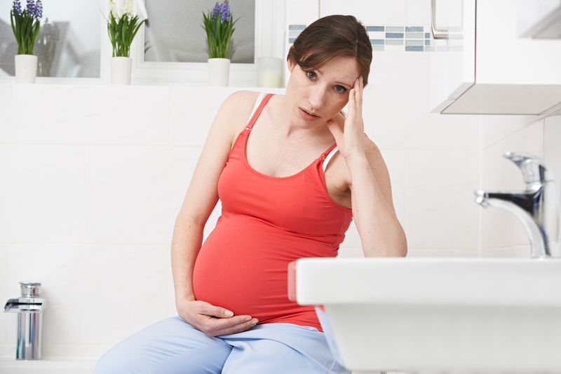 Expecting mom feeling billious in bathroom