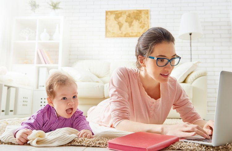 Mom with young baby on computer