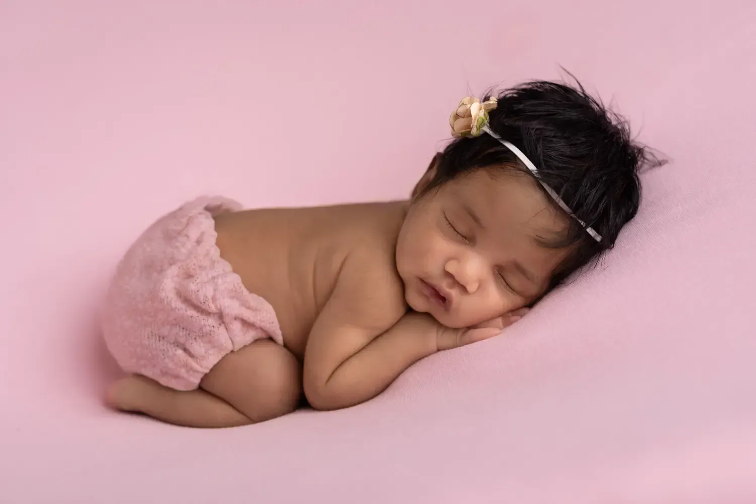 Glendale Newborn gitl in pink peacfully sleeping on tummy