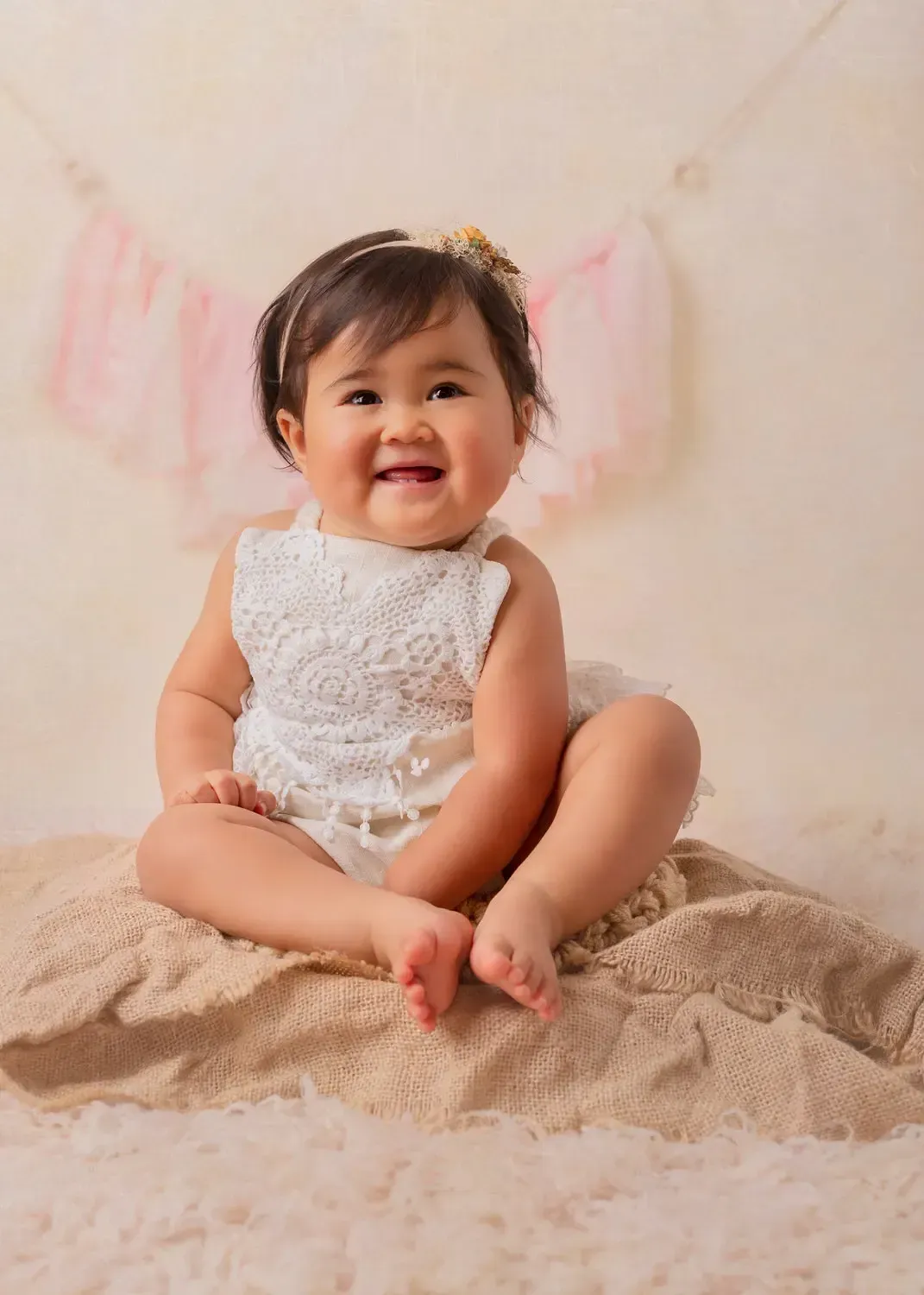 Glendale baby photographer Girl in white romper in bucket. First Birthday Portrait