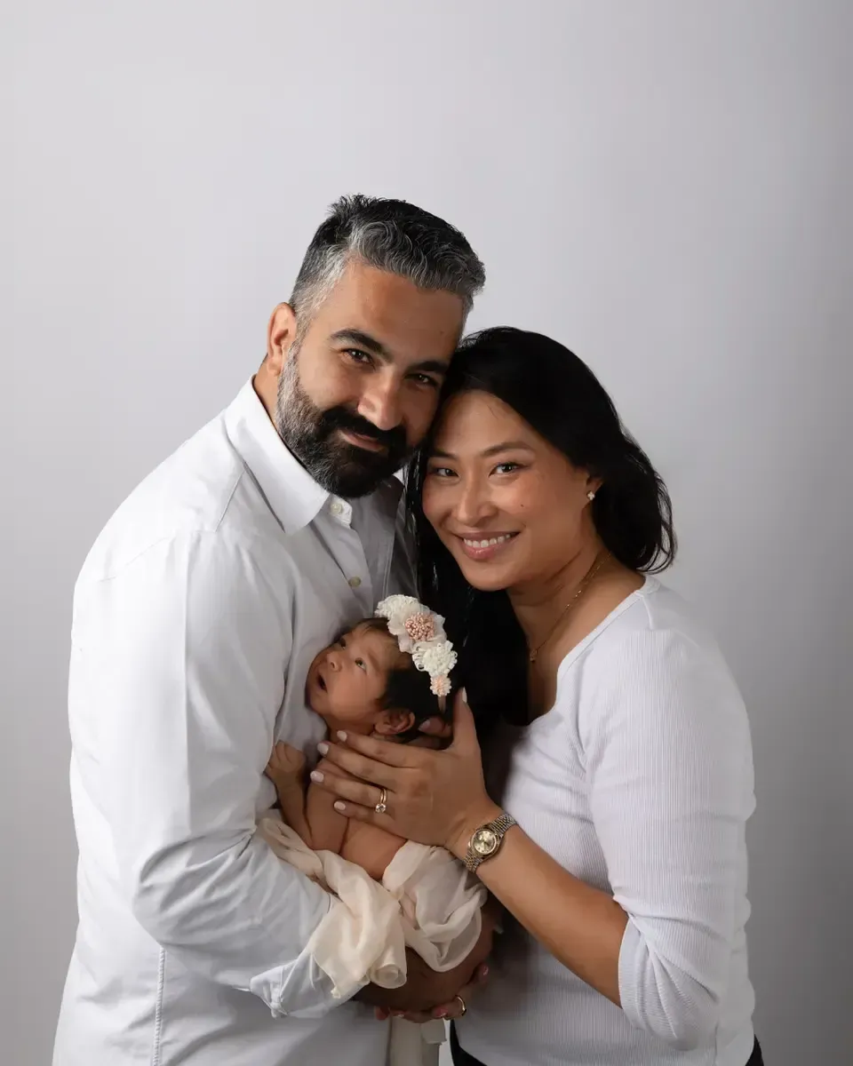 Mom and dad holding their new baby girl.