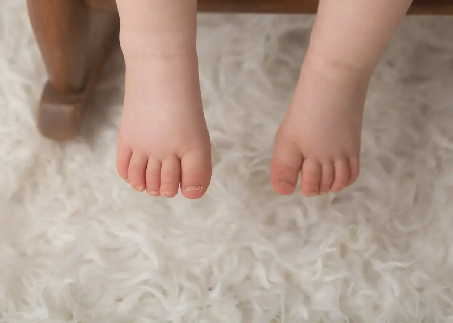 Baby girl first birthday. Close up of feet.