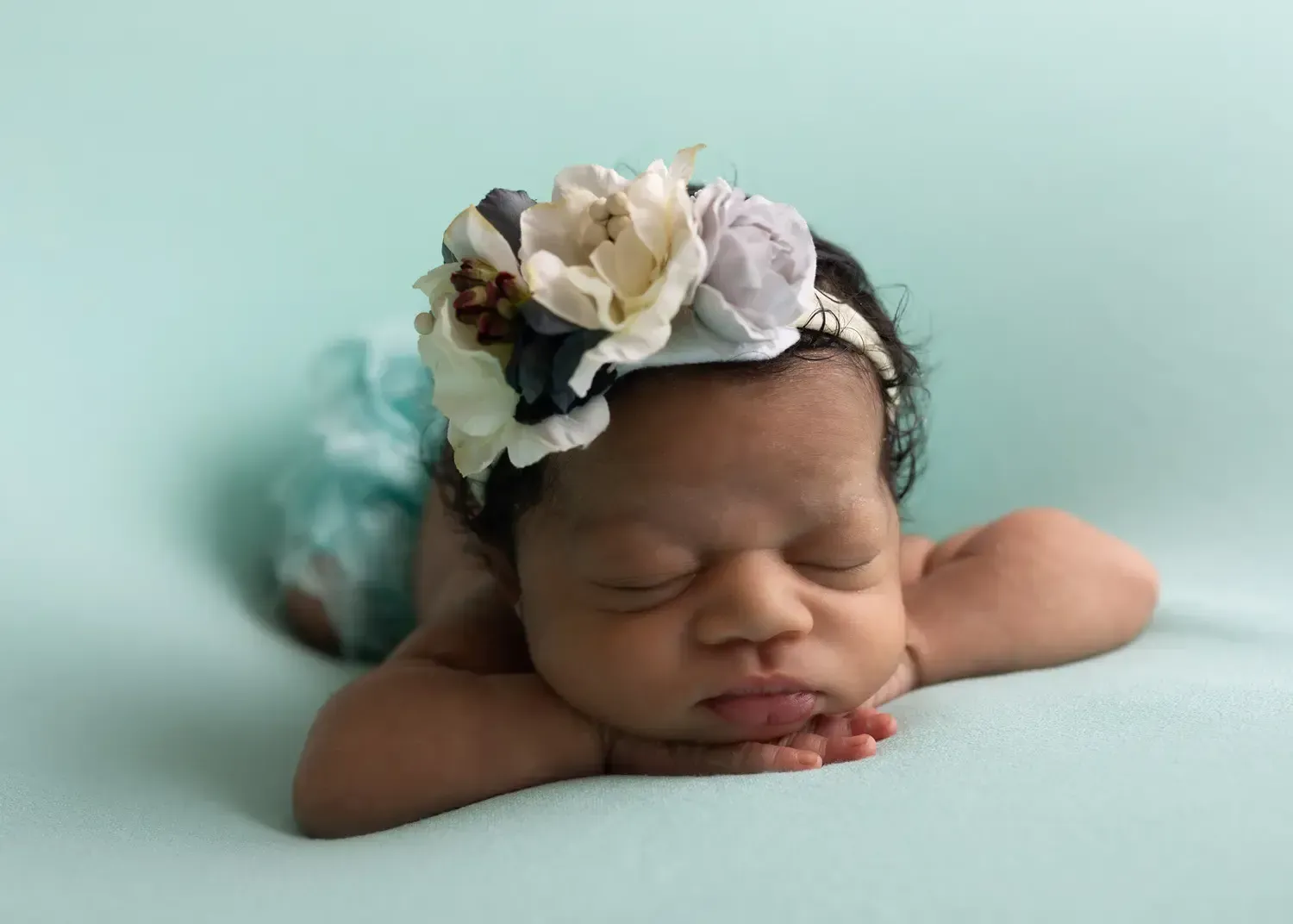 Los Angeles Newborn photo of Newborn baby with chin on hands.