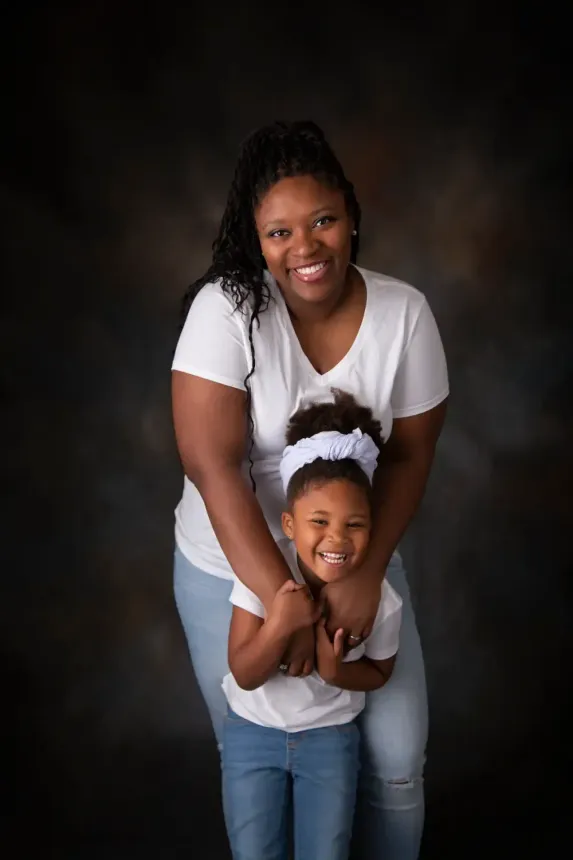 African American Mother and daughter. In jeans and white t shirts.