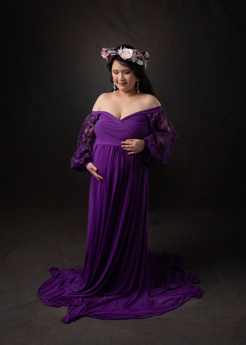 Expecting Asian mom in purple gown.