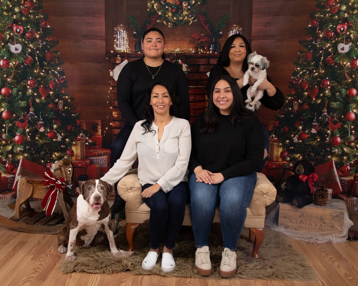 Family Holiday Photo with dogs in front of fire place