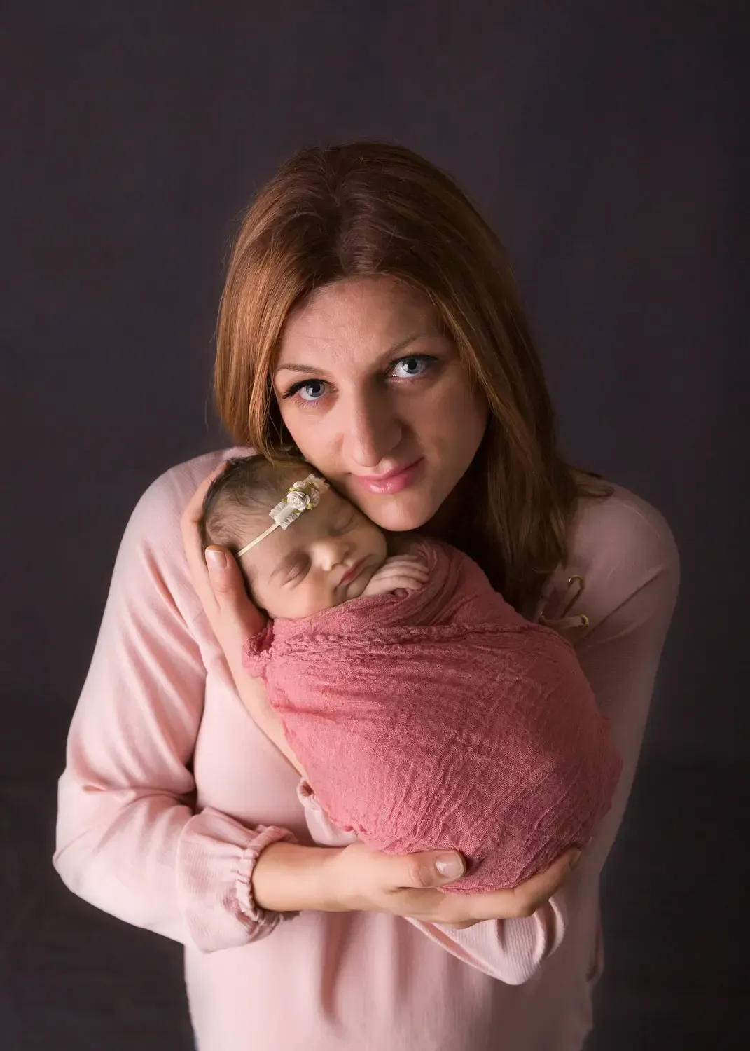 Mom holding newborn baby girl.